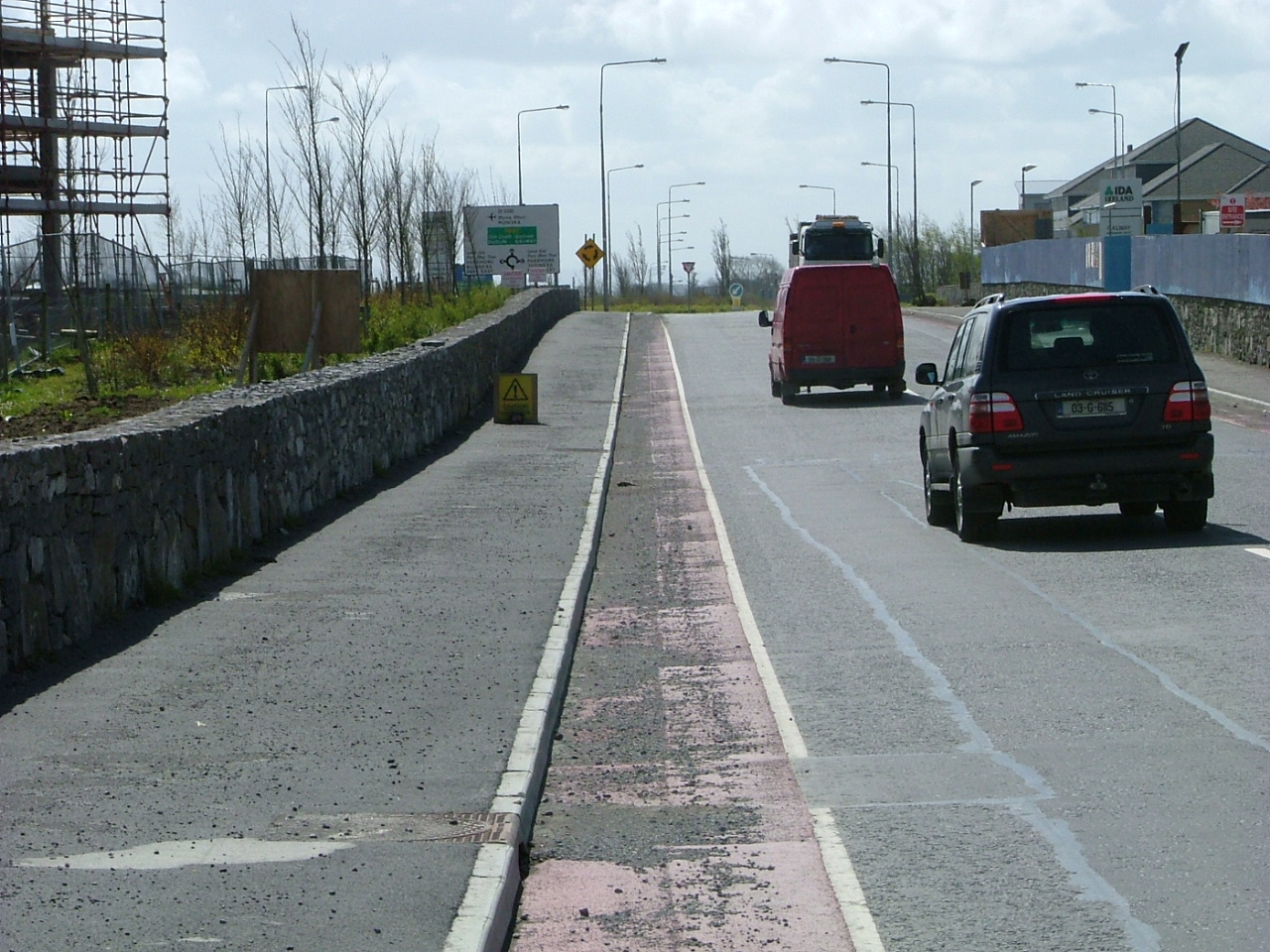 Parkmore Road - gravel and dirt in the cycle lane. Cycle lane is barely visible.